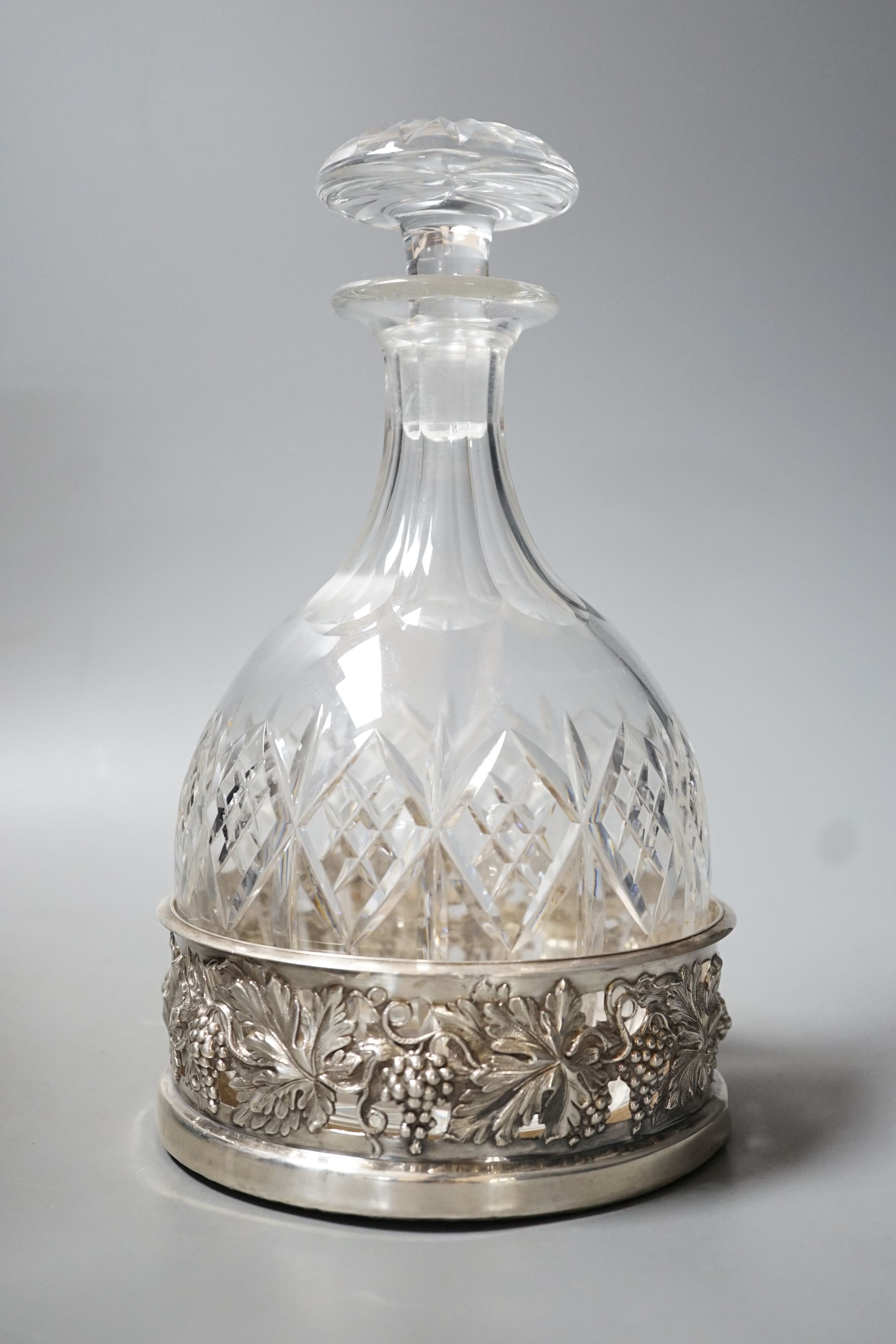A William IV pierced silver mounted wine coaster, with fruiting vine decoration, Howard, Battie & Hawksworth, Sheffield, 1833, 13.9cm(repair), together with a cut glass decanter.